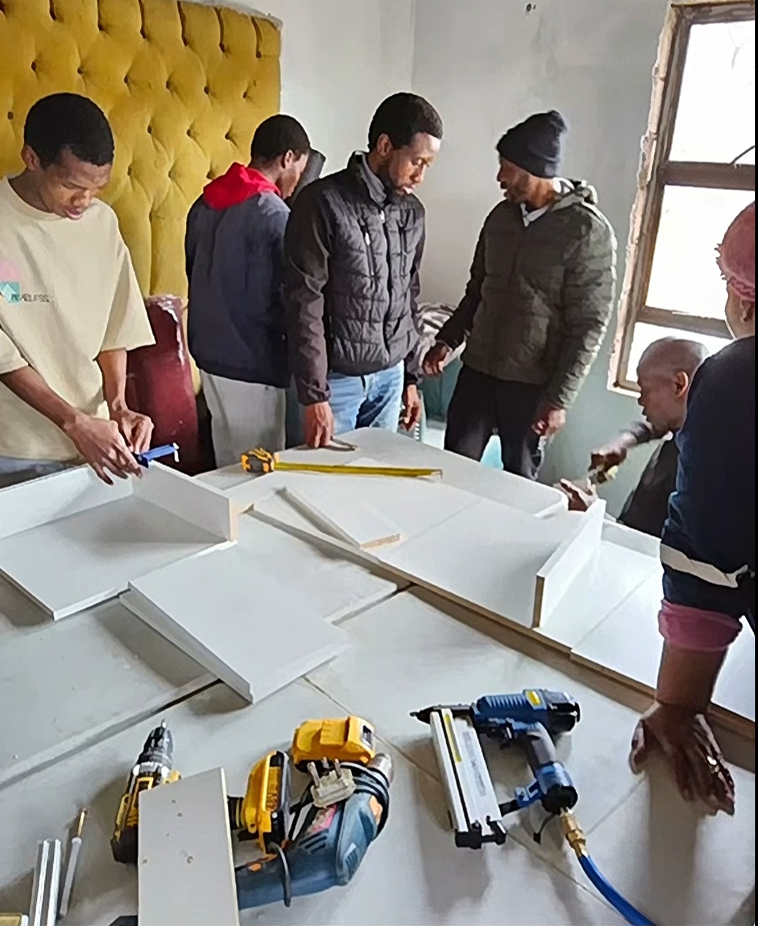 Students assembling furniture during training