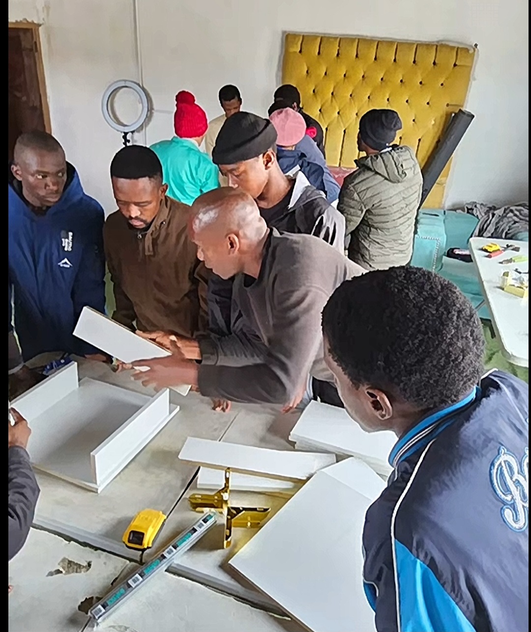 Students learning carpentry in the workshop